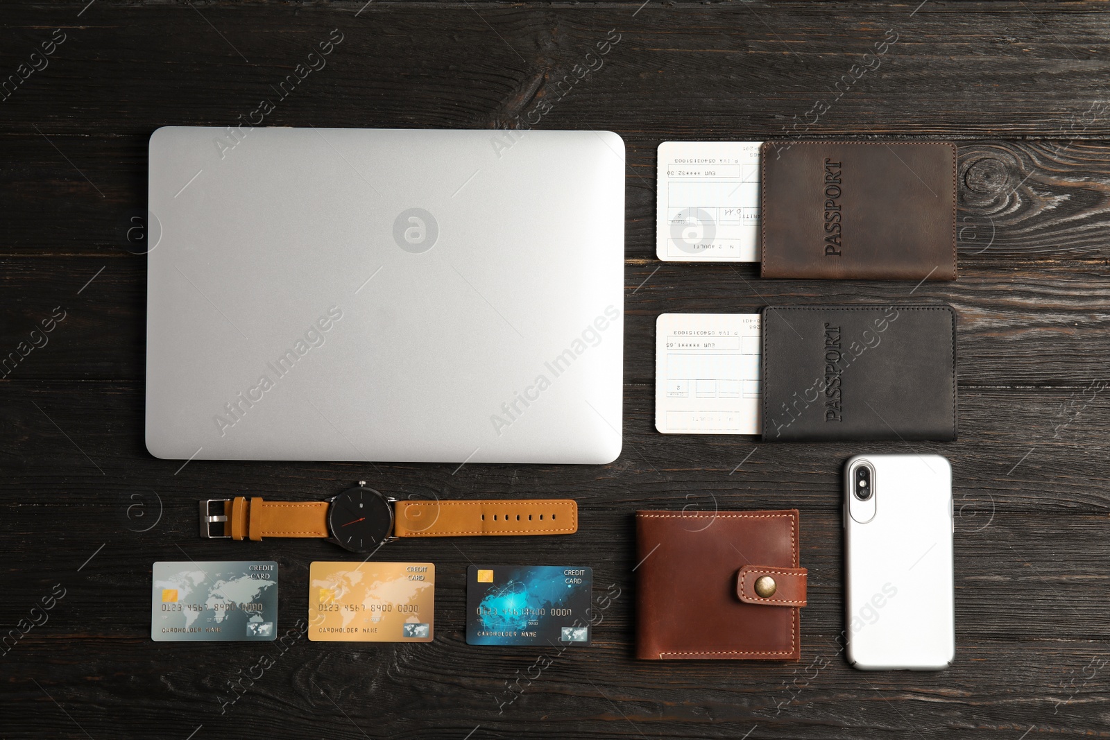 Photo of Flat lay composition with laptop and passports on wooden background. Travel agency