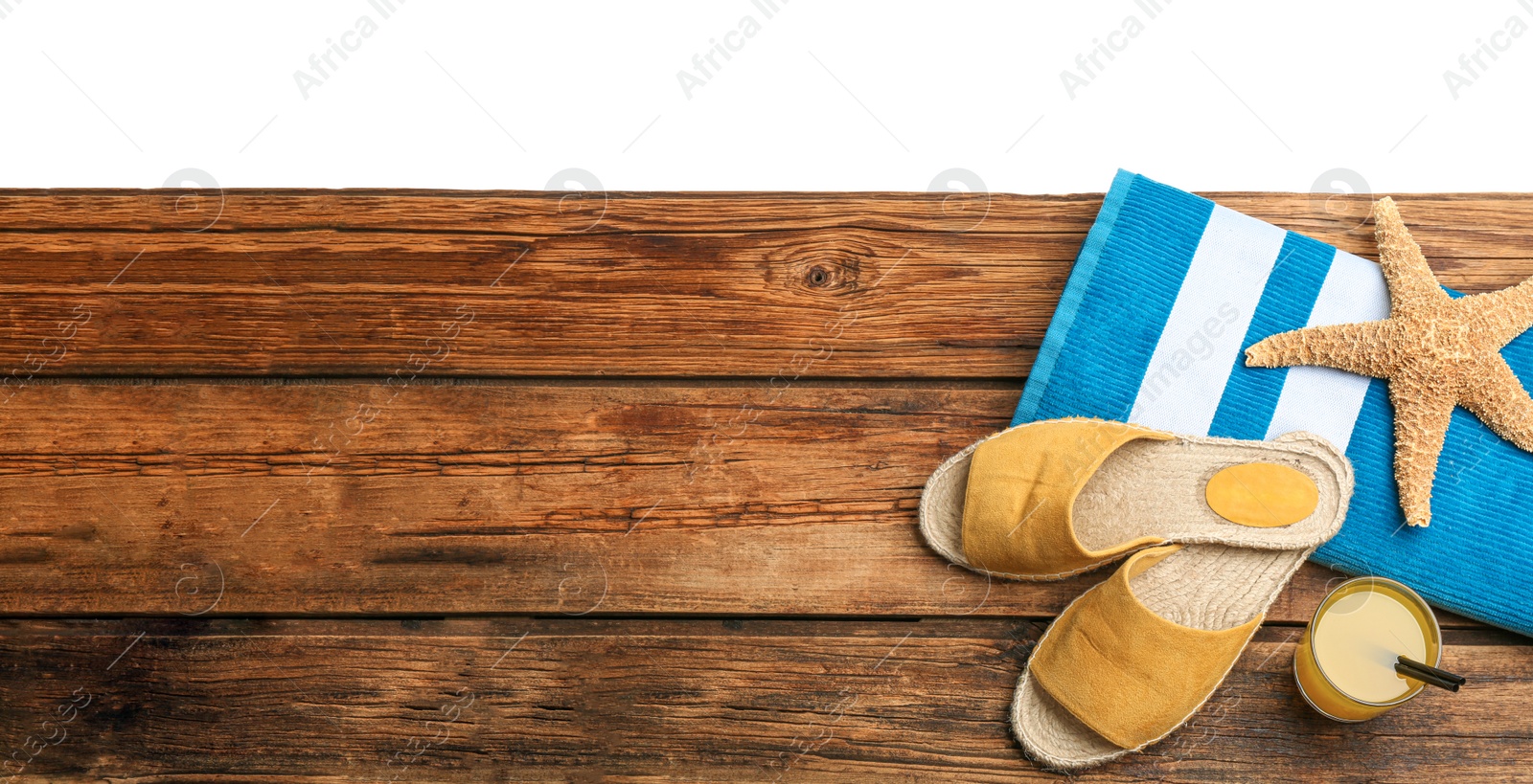 Photo of Beach accessories and drink on wooden table, flat lay. Space for text