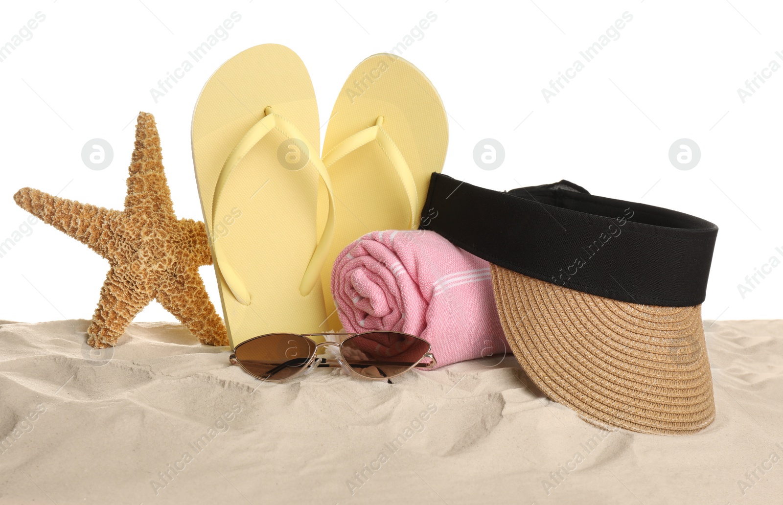 Photo of Different beach objects on sand against white background