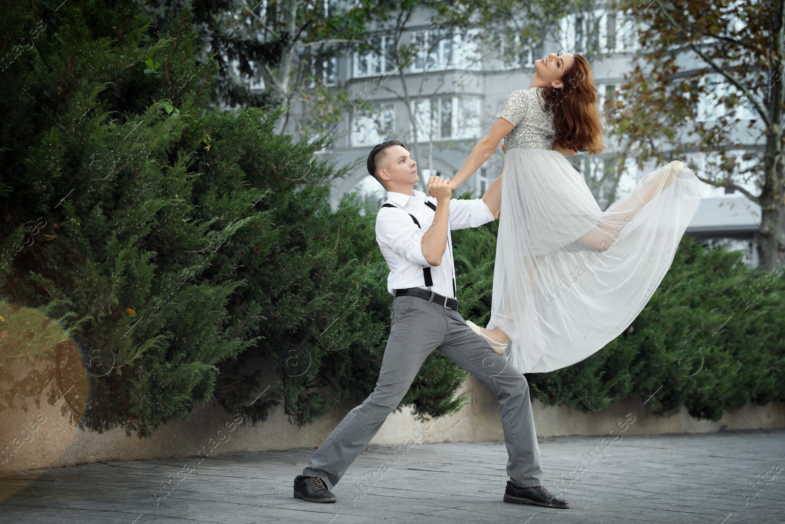 Photo of Beautiful young couple practicing dance moves outdoors