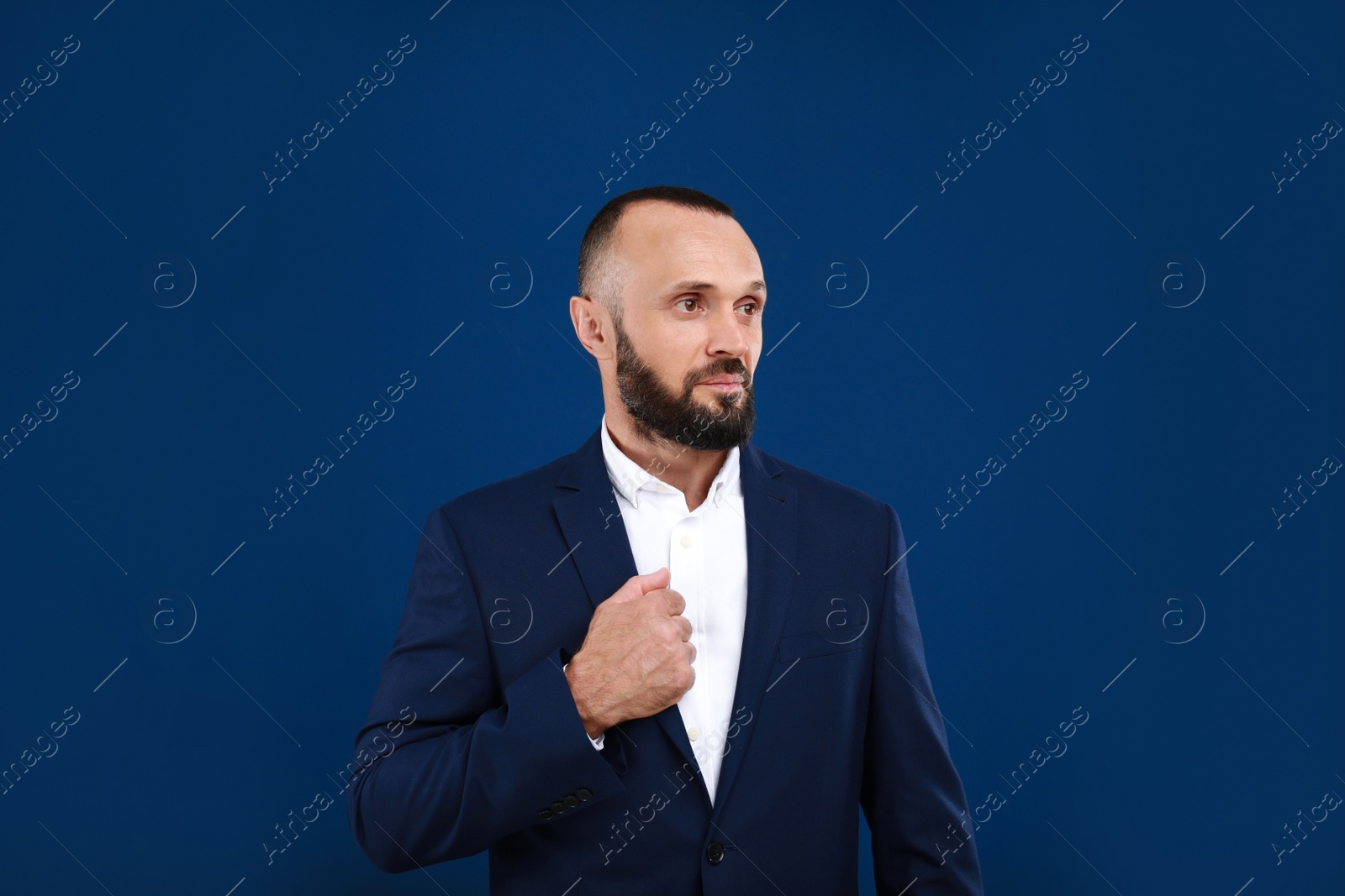 Photo of Portrait of handsome man on blue background