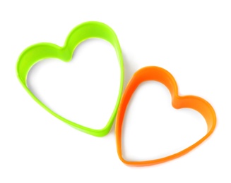 Photo of Heart shaped cookie cutters on white background, top view