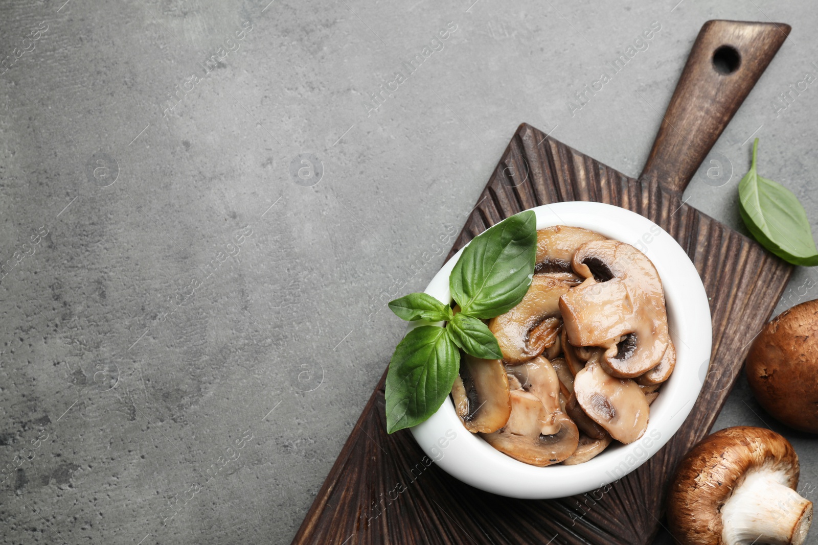 Photo of Flat lay composition with delicious cooked mushrooms on table, space for text