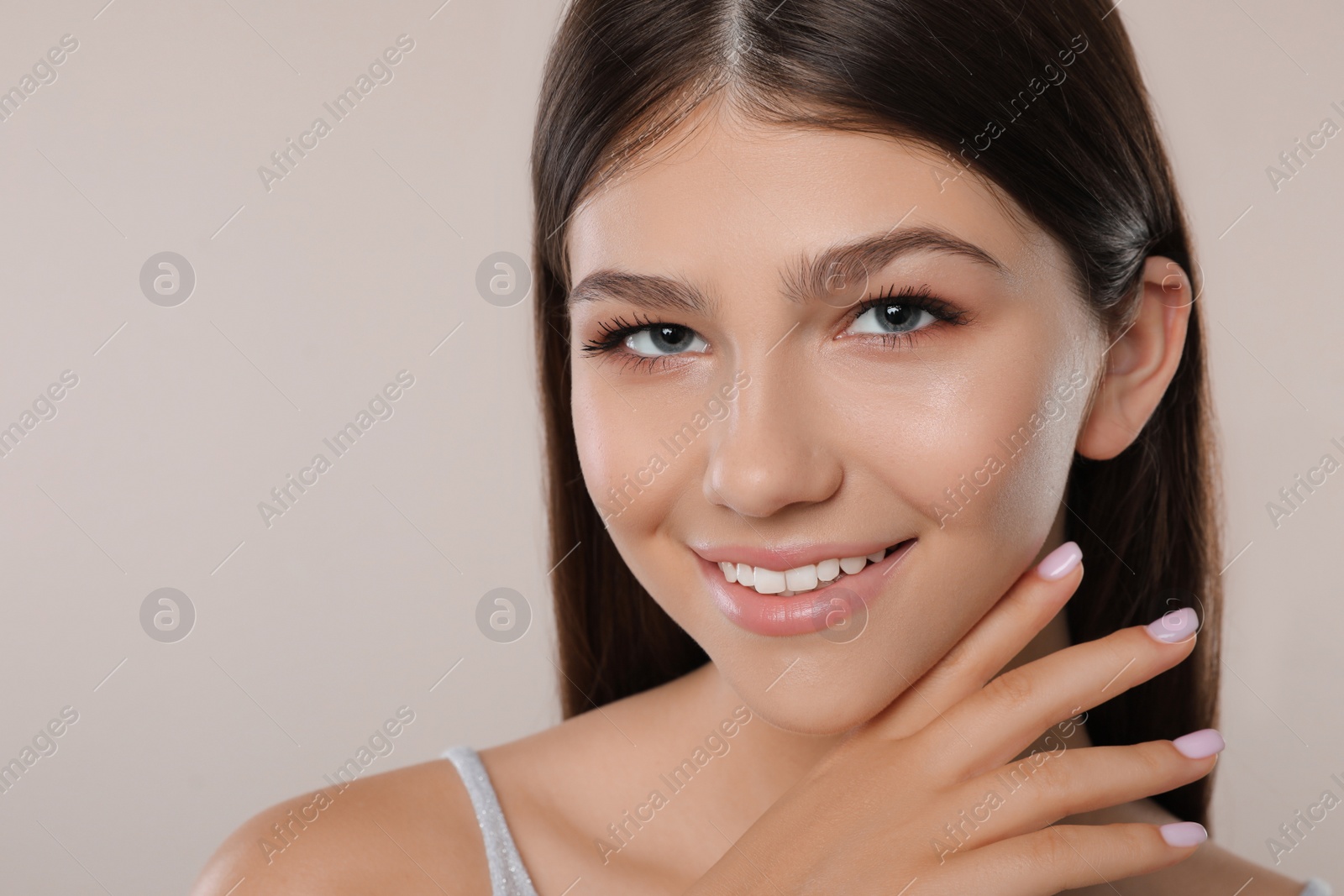 Photo of Pretty girl on light background, closeup. Beautiful face with perfect smooth skin