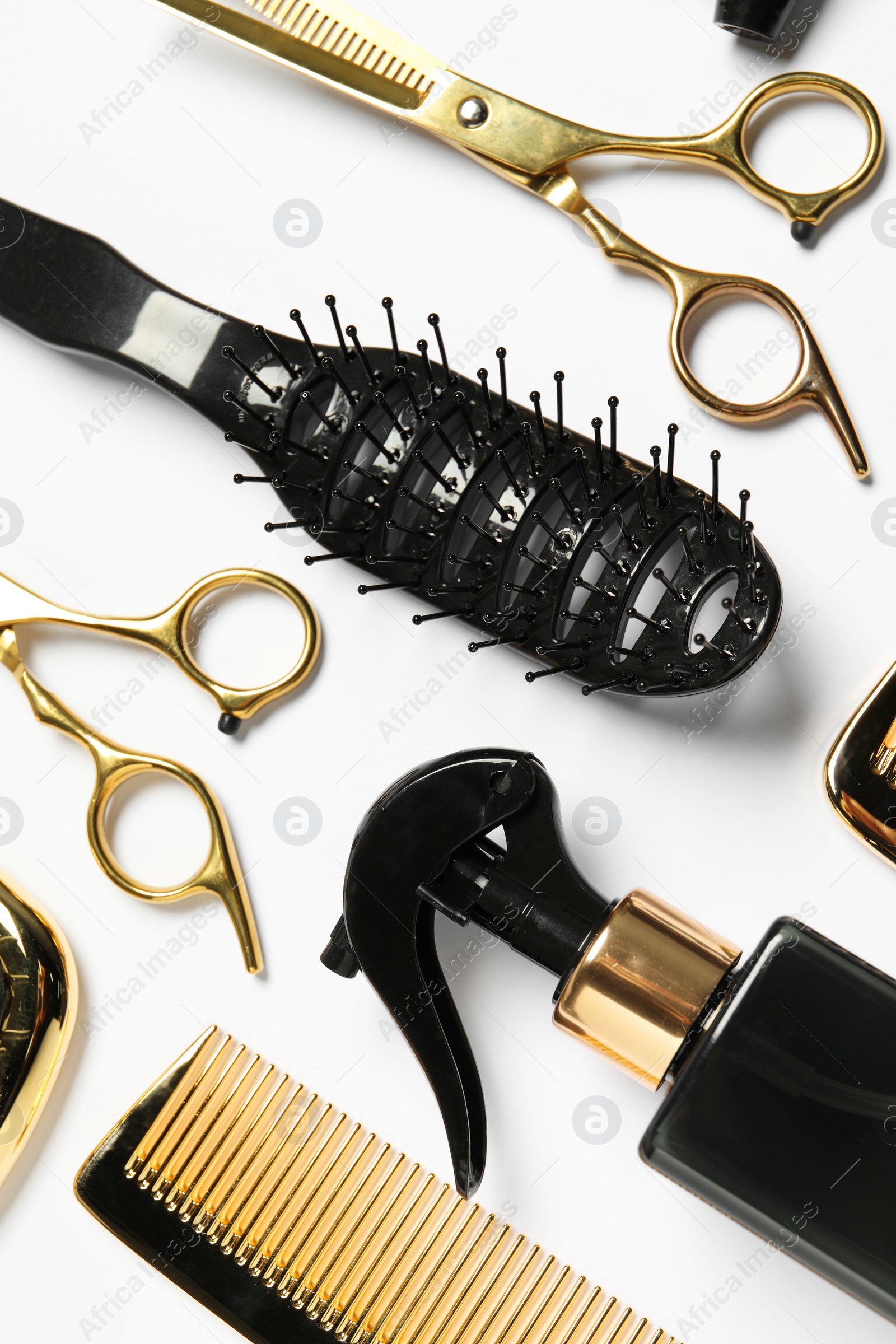 Photo of Hairdressing tools on white background, flat lay