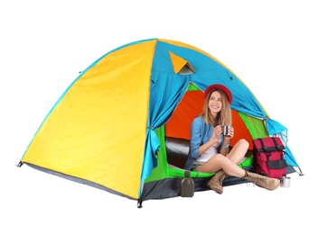 Photo of Young beautiful woman sitting in tourist tent on white background