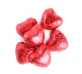 Heart shaped chocolate candies on white background, top view