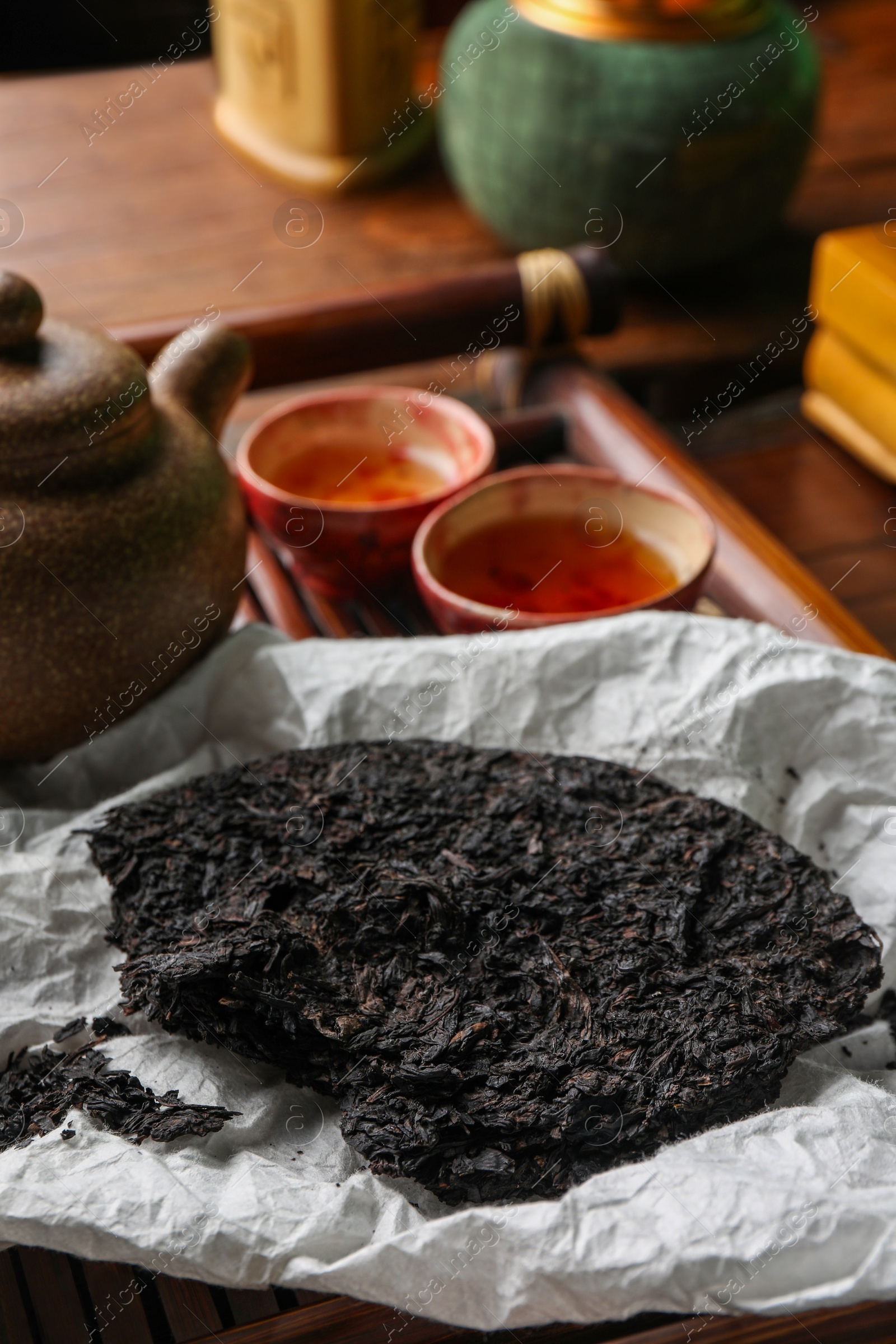 Photo of Broken disc shaped pu-erh tea and on table