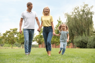 Happy family running in park on summer day