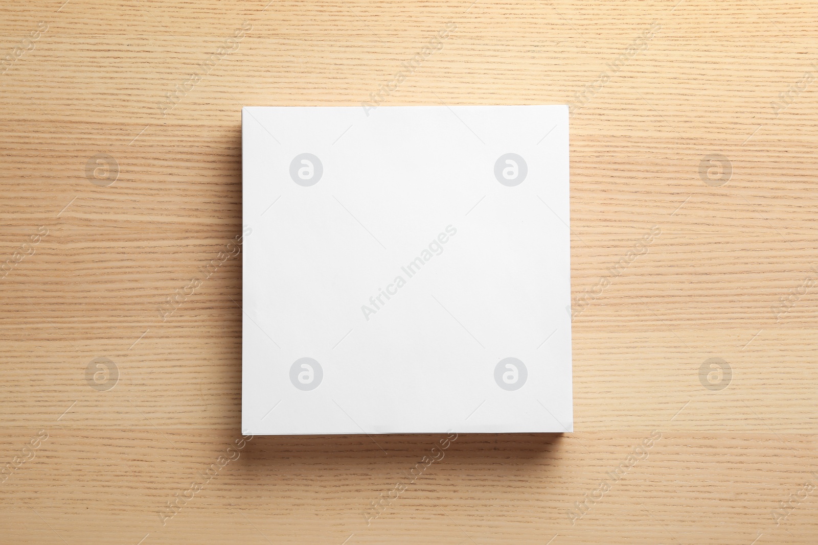 Photo of Stack of blank paper sheets for brochure on wooden background, top view. Mock up