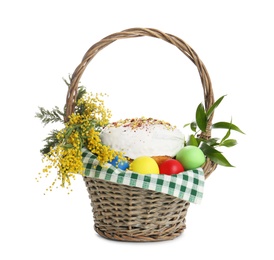 Photo of Basket with delicious Easter cake, dyed eggs and flowers on white background