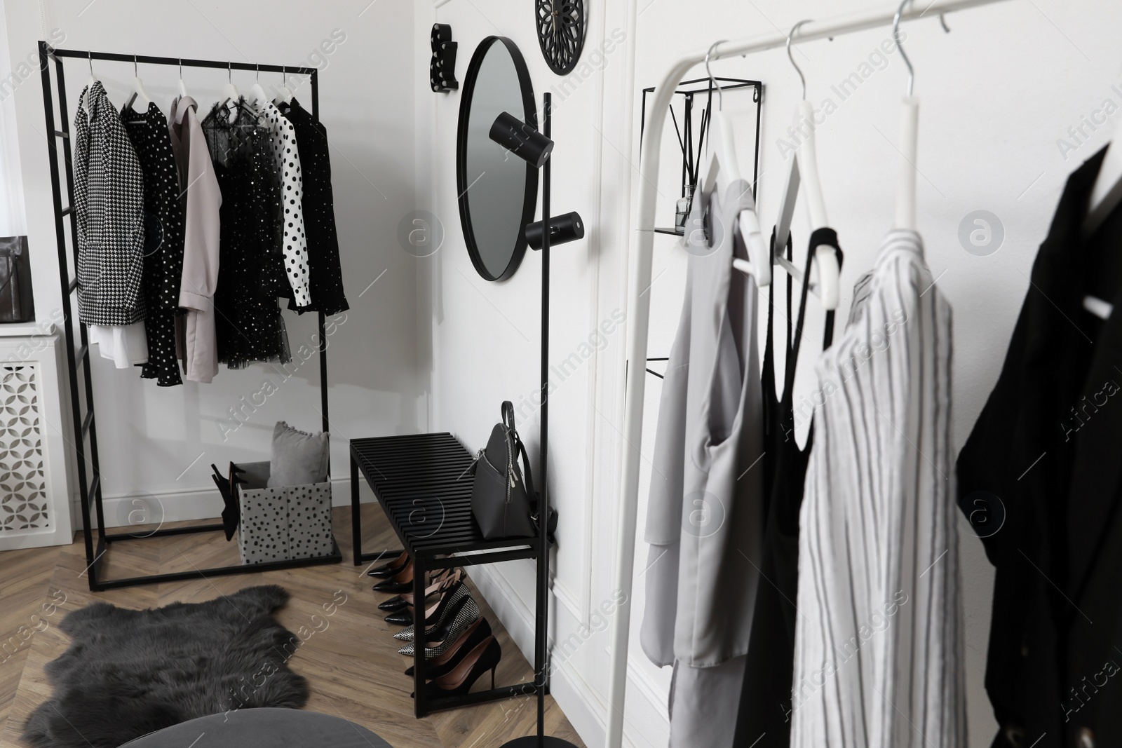 Photo of Dressing room with stylish clothes, shoes and accessories. Elegant interior design