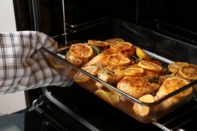 Photo of Taking delicious lemon chicken out of oven