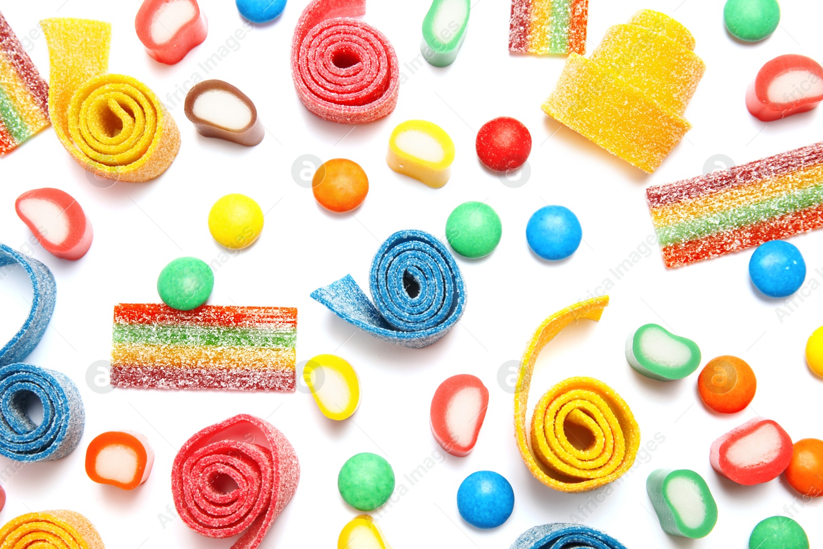 Photo of Many different yummy candies on white background, top view