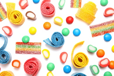 Many different yummy candies on white background, top view