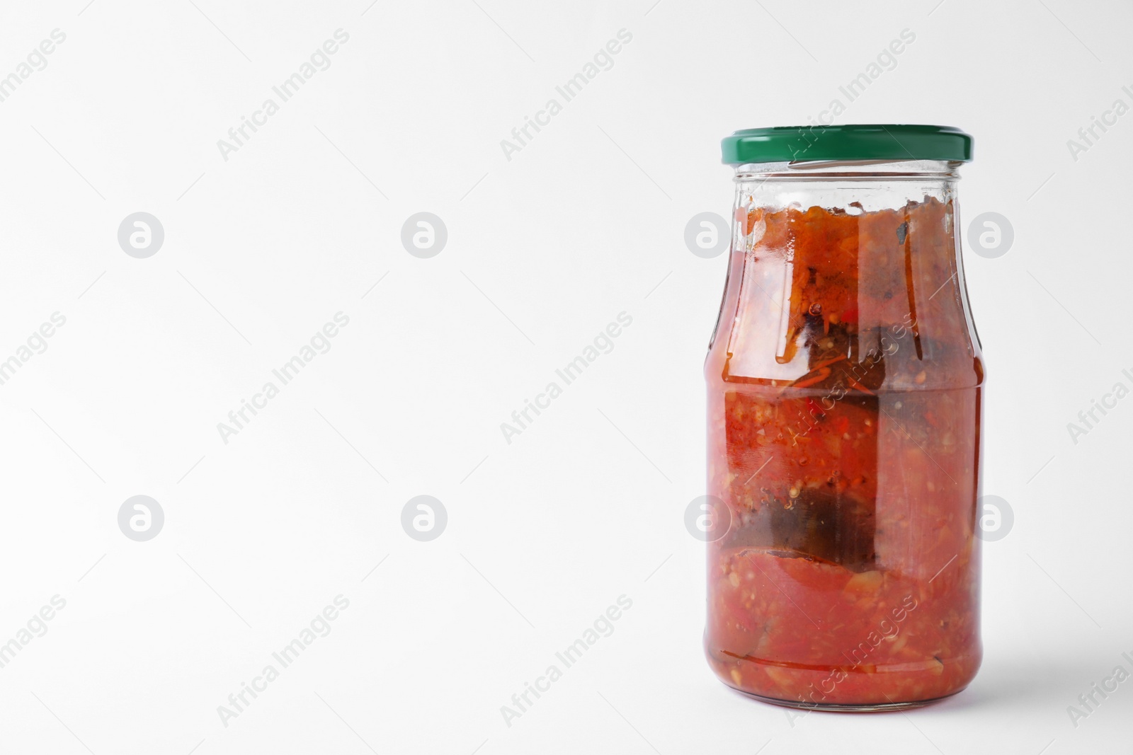 Photo of Jar with tasty vegetable sauce on white background. Pickled food