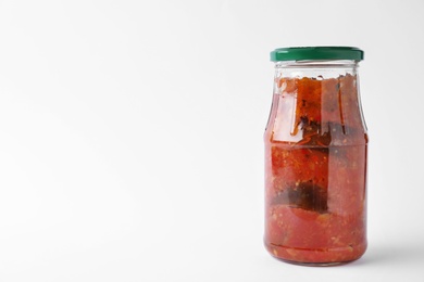 Jar with tasty vegetable sauce on white background. Pickled food