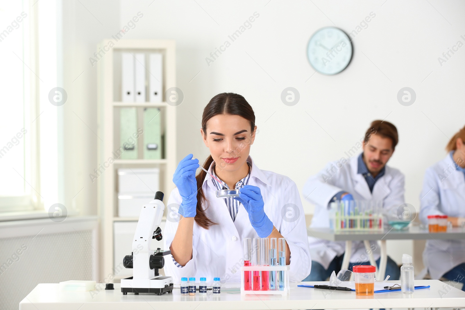 Photo of Female scientist working at table in laboratory. Research and analysis