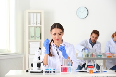 Female scientist working at table in laboratory. Research and analysis