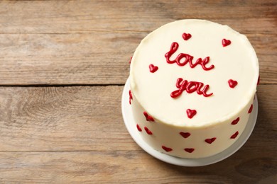 Photo of Bento cake with text Love You on wooden table, space for text. St. Valentine's day surprise