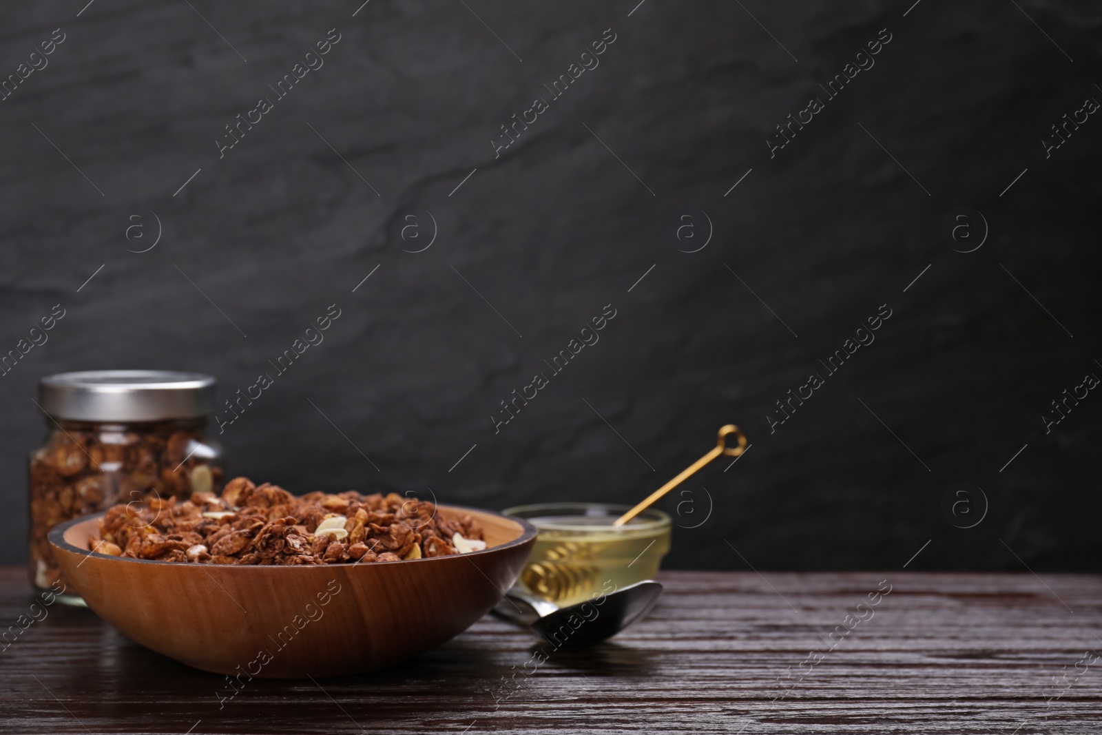 Photo of Tasty granola on wooden table. Space for text