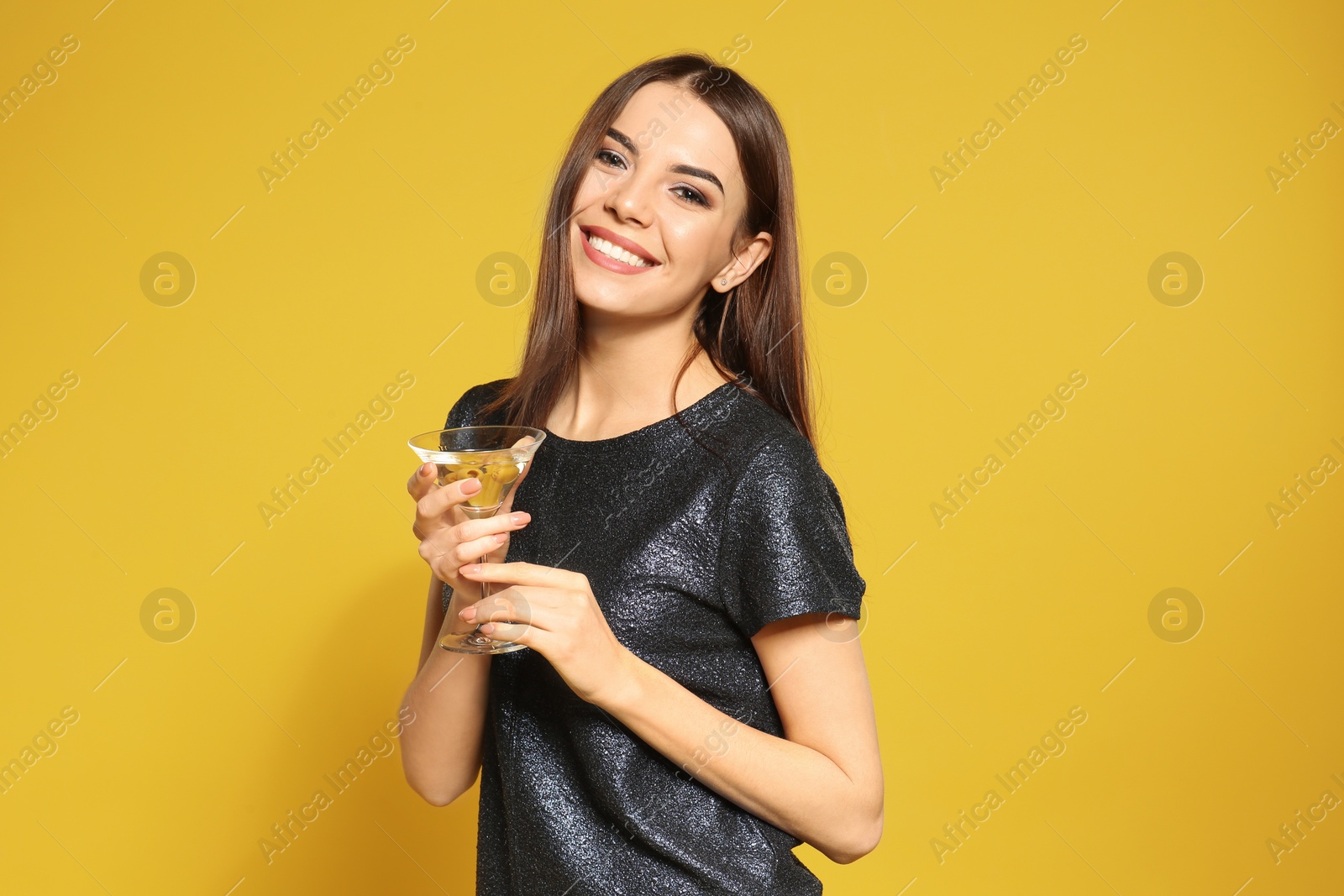 Photo of Beautiful young woman with glass of martini cocktail on color background