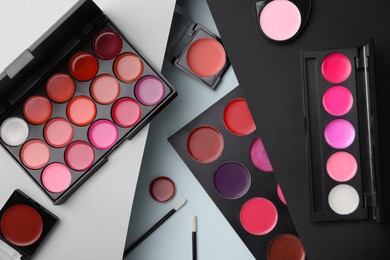 Photo of Flat lay composition with cream lipstick palettes on color background. Professional cosmetic product