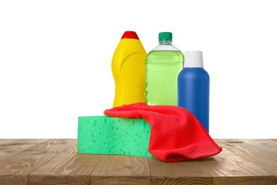 Photo of Bottles, cloth and car wash sponge on wooden table against white background