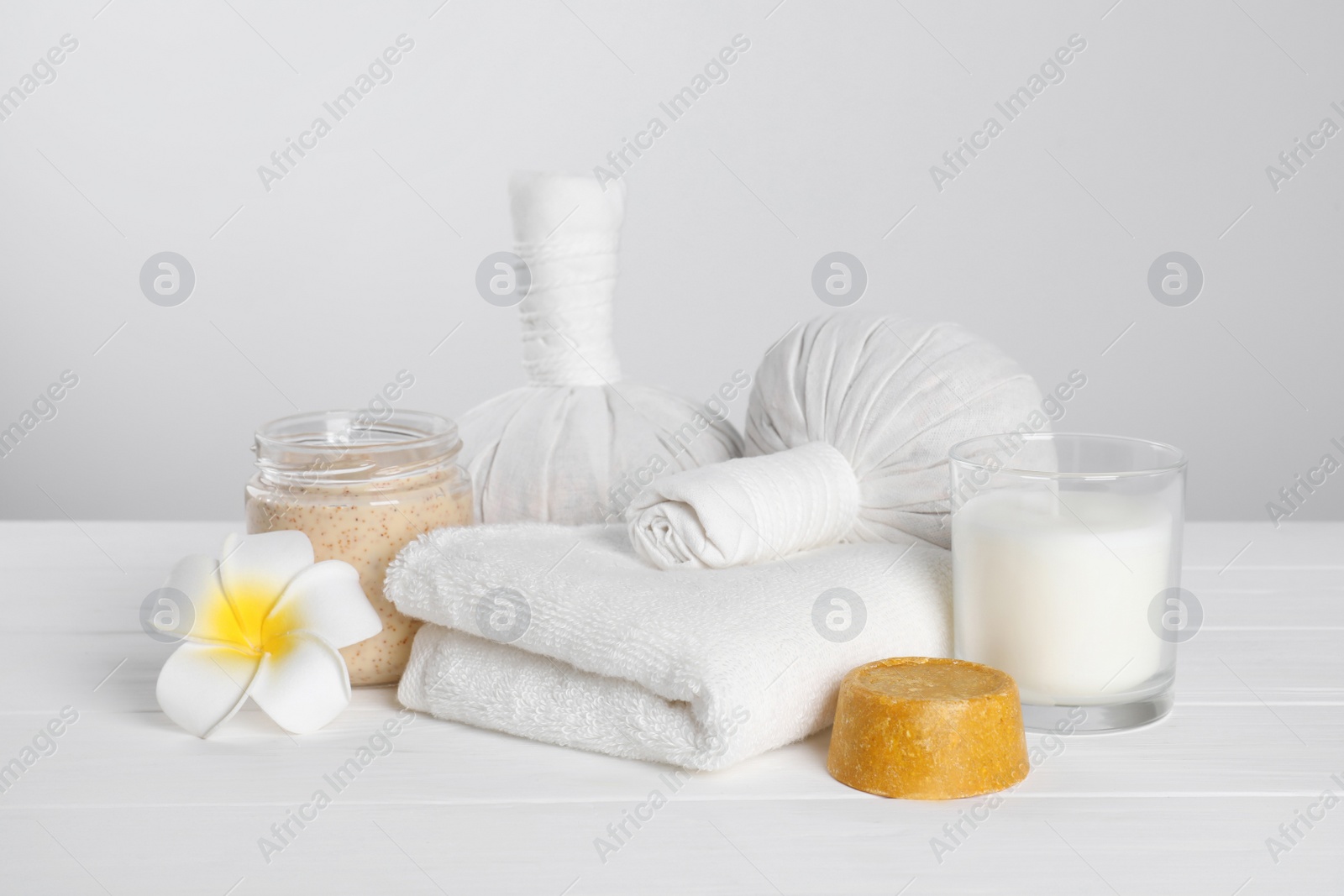 Photo of Spa composition with care products on white wooden table