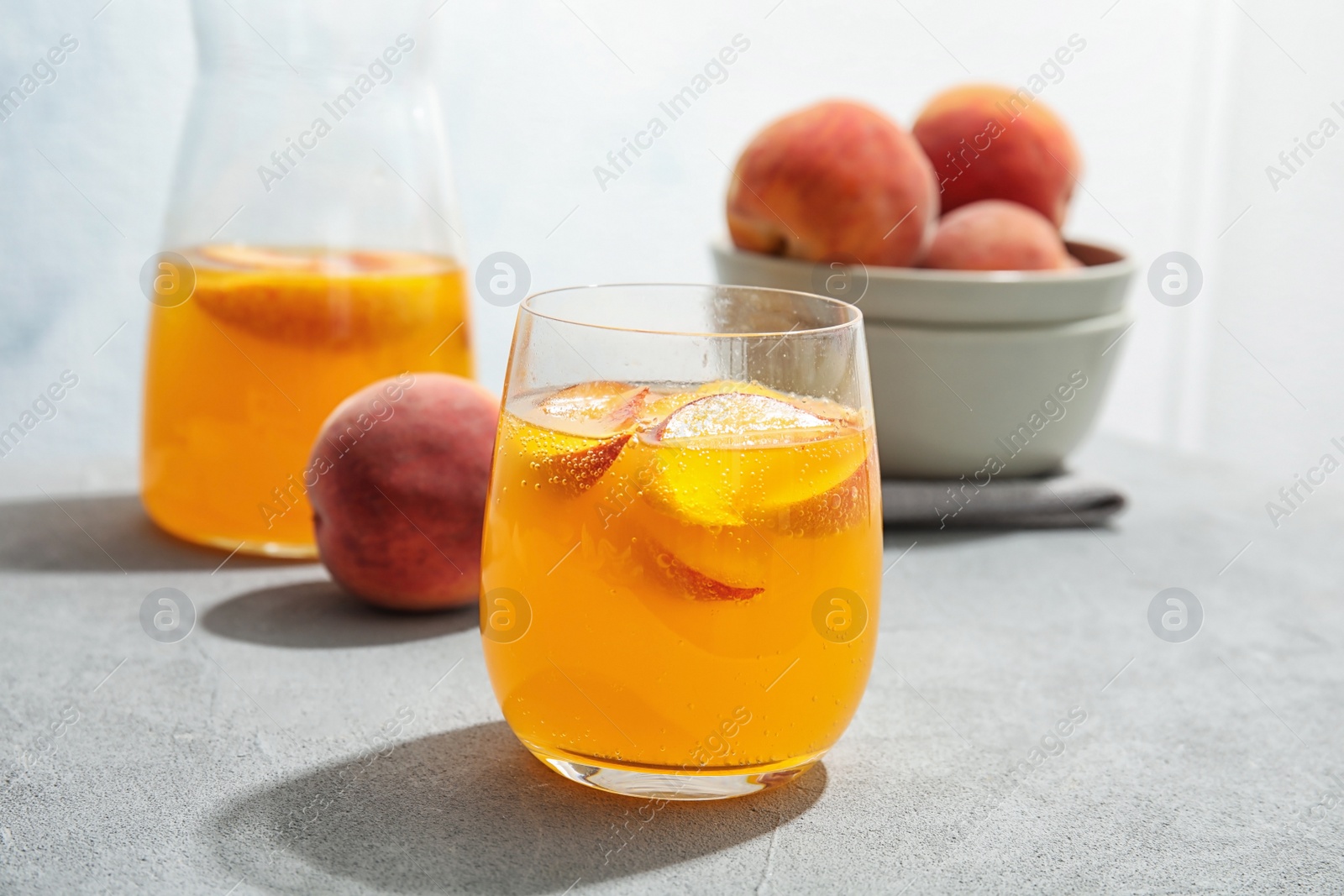 Photo of Tasty peach cocktail on table. Refreshing drink