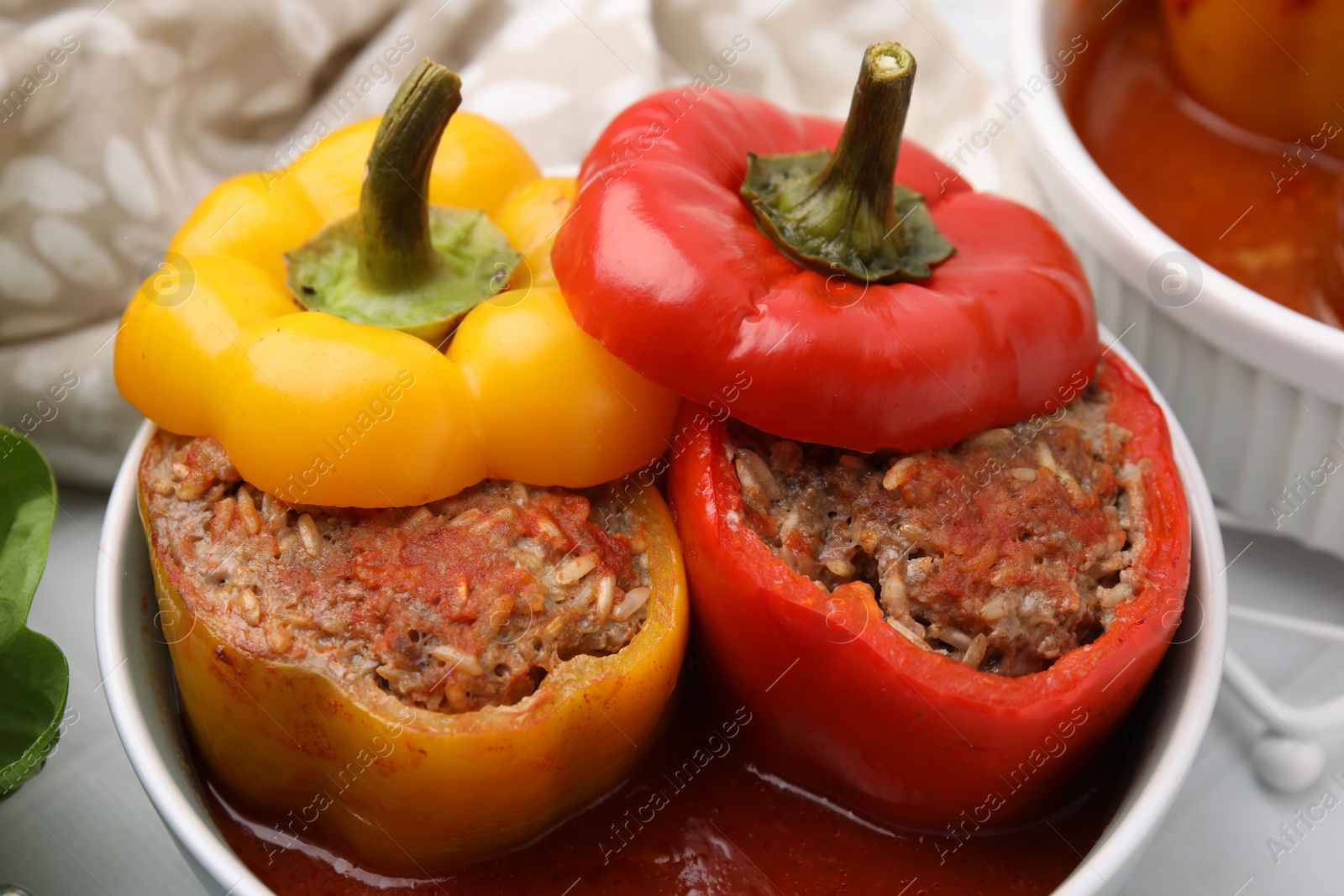 Photo of Delicious stuffed bell peppers on white table, closeup