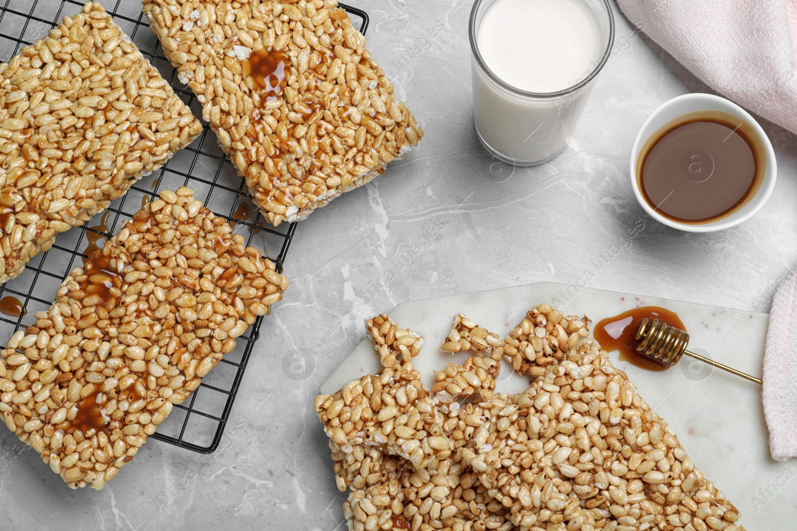 Photo of Delicious rice crispy treats on grey table, flat lay