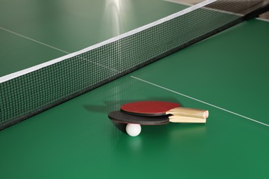 Rackets and ball on ping pong table