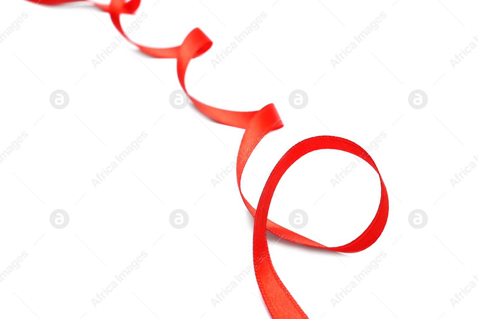 Photo of Simple red ribbon on white background, closeup