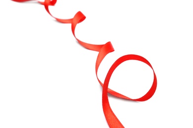 Photo of Simple red ribbon on white background, closeup