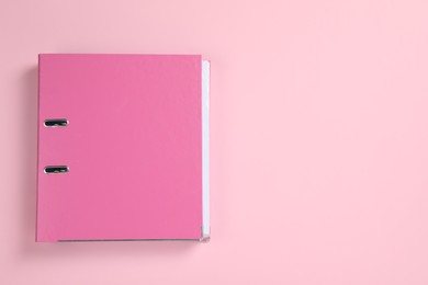Photo of Office folder on pink background, top view. Space for text