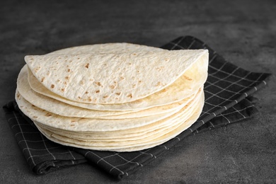 Photo of Stack of corn tortillas on table. Unleavened bread