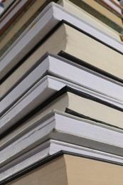 Photo of Stack of many different hardcover books as background, closeup