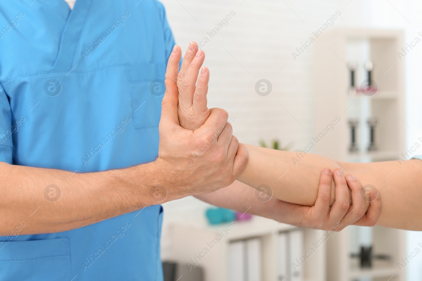 Photo of Physiotherapist working with patient in clinic, closeup. Rehabilitation therapy
