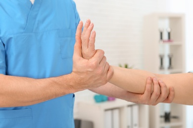 Photo of Physiotherapist working with patient in clinic, closeup. Rehabilitation therapy