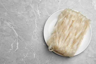 Photo of Block of rice noodles on light grey marble table, top view. Space for text