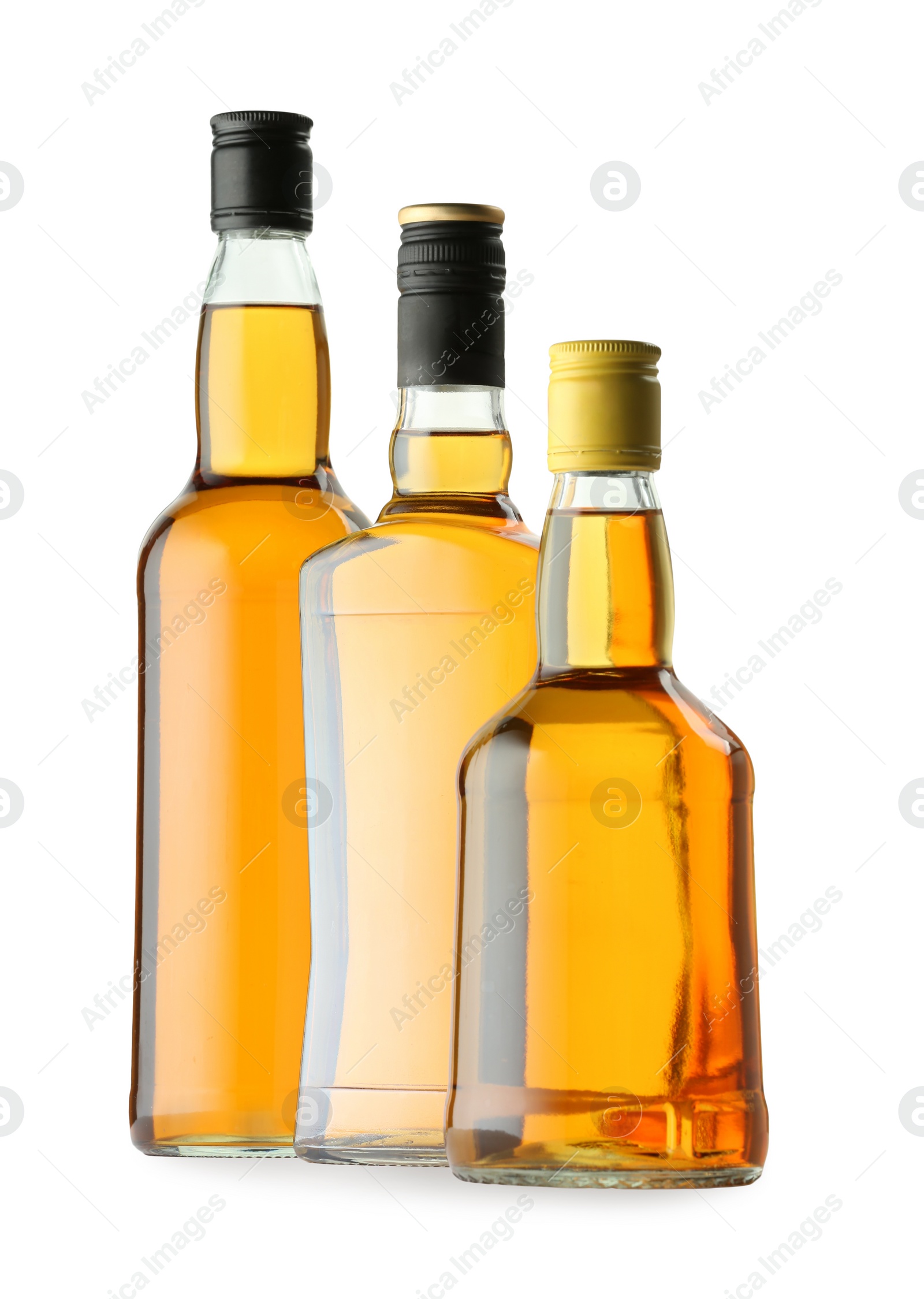 Photo of Different sorts of whiskey in glass bottles isolated on white