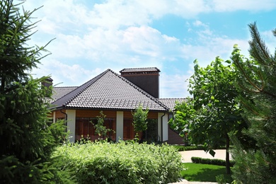 Photo of Modern house and beautiful garden on sunny day