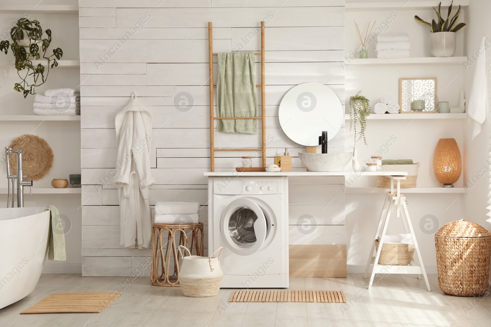 Photo of Stylish bathroom interior with modern washing machine