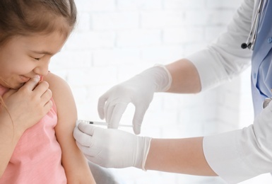 Photo of Doctor vaccinating little girl in hospital