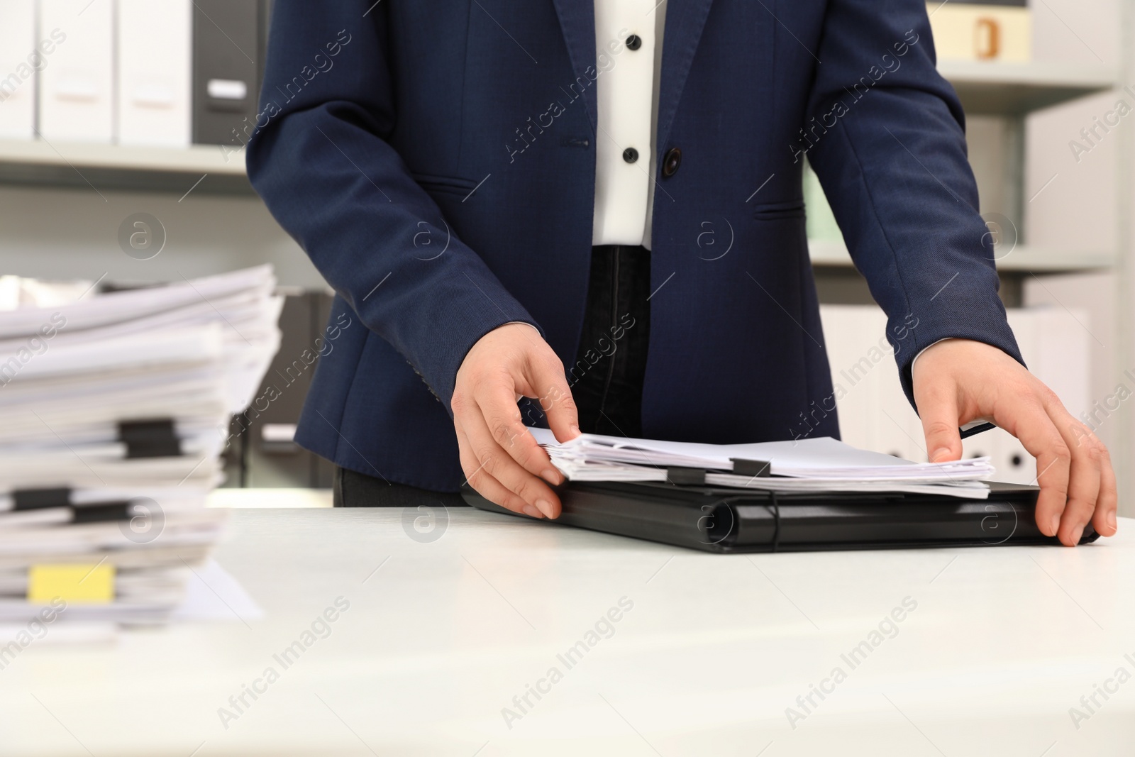 Photo of Woman working with documents at table in office, closeup