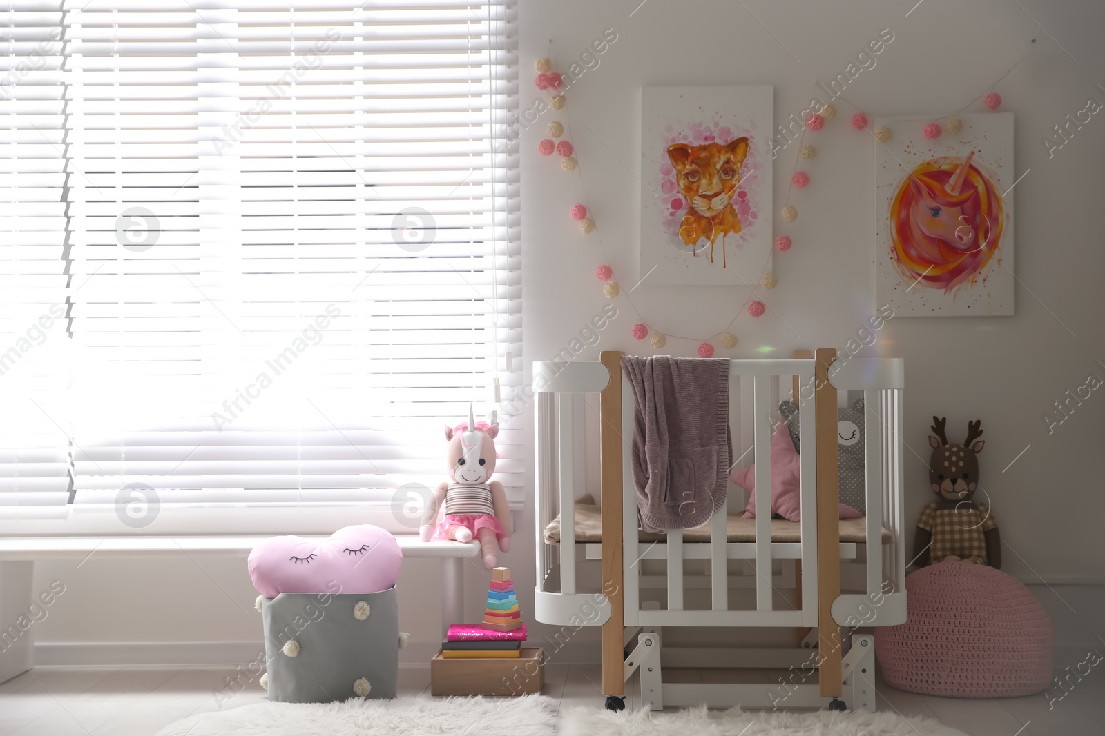 Photo of Cute pictures and crib in baby room interior