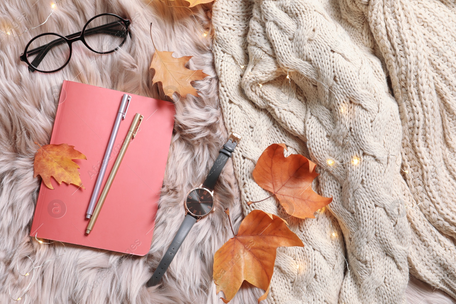 Photo of Flat lay composition with book, autumn leaves and warm clothes on fuzzy rug