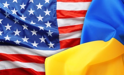 Image of National flags of Ukraine and USA symbolizing partnership between countries