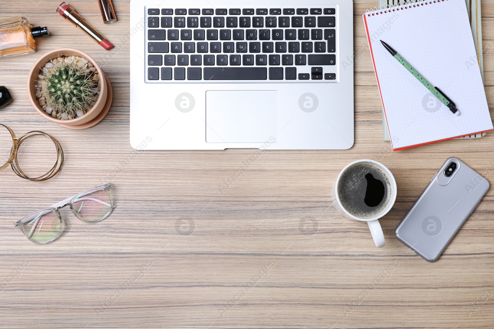 Photo of Flat lay composition with laptop and beauty blogger's stuff on wooden table, space for text